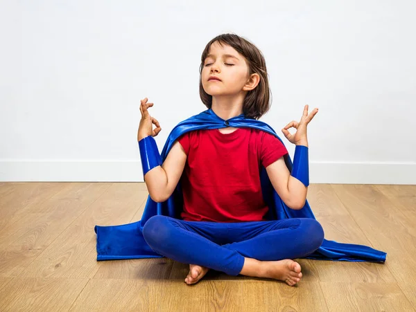 Orgoglioso bambino supereroe praticare yoga e meditazione per umorismo zen — Foto Stock