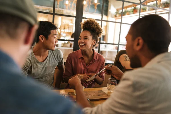 Diverse Group Smiling Young Friends Sitting Table Bistro Talking Together — Stock Photo, Image