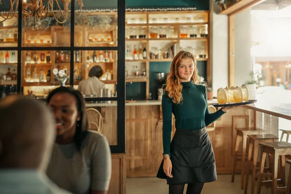 Portrait Young Waitress Standing Trendy Bistro Full Customers Carrying Tray — Stock Photo, Image