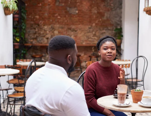 Young African Woman Talking Male Friend Drinking Coffee While Sitting — Stock Photo, Image