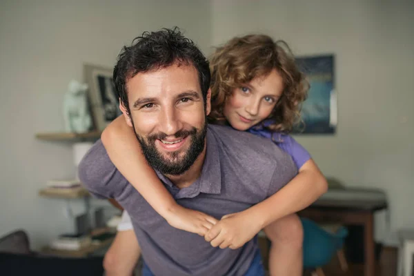 Smiling Dad Giving His Young Son Piggyback Ride While Having — Stock Photo, Image