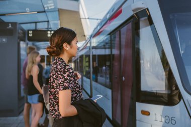Onu sabah sırasında şehirde metro bir tren kuruluna hakkında bir peronda duran Genç Asyalı işkadını gidip