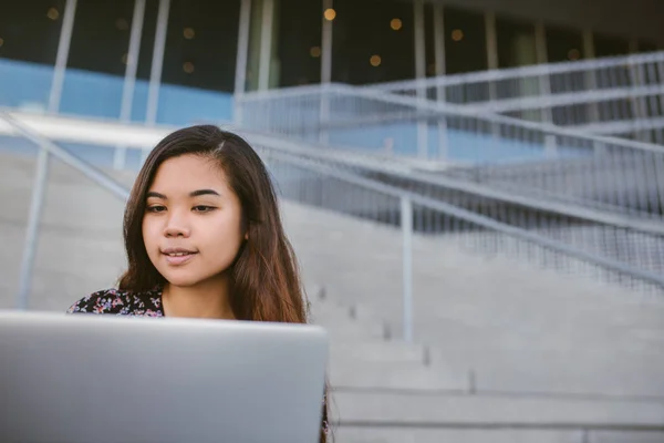Улыбающийся Студент Азиатского Университета Сидящий Снаружи Ступеньках Кампуса Работающий Ноутбуке — стоковое фото
