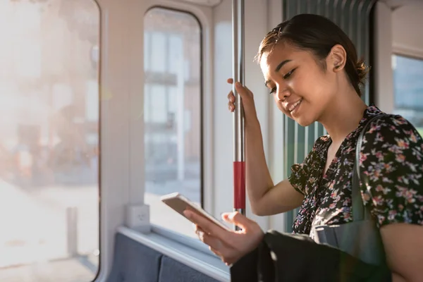 Smiling Young Asian Businesswoman Catching Social Media While Riding Train — Stock Photo, Image