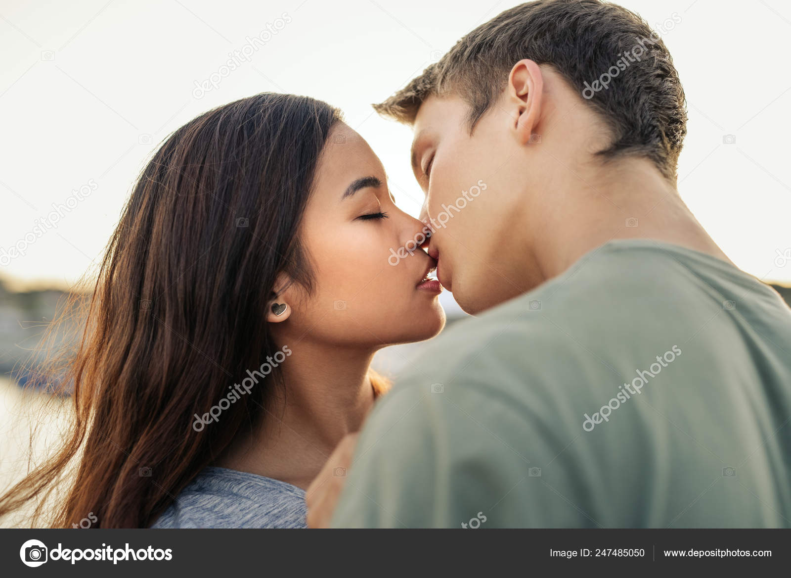 Romantic Young Couple Kissing Each Other While Standing Arm Arm Stock Photo Image By C Mavoimages