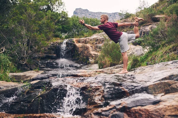 Fit Man Standing Rock Doing Dancer Pose While Practicing Yoga — Stock Photo, Image