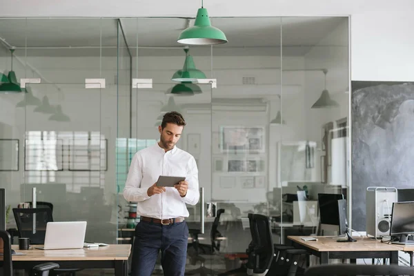 Focused Young Businessman Working Online Digital Tablet While Standing Alone — Stock Photo, Image