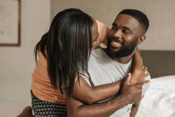Smiling Young African American Woman Hugging Her Husband While Sitting — Stock Photo, Image