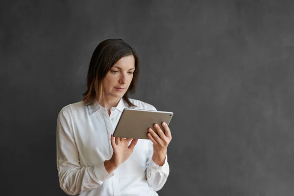 Bizneswoman Pracuje Online Tabletem Cyfrowym Stojąc Samotnie Przed Pustą Tablicą — Zdjęcie stockowe