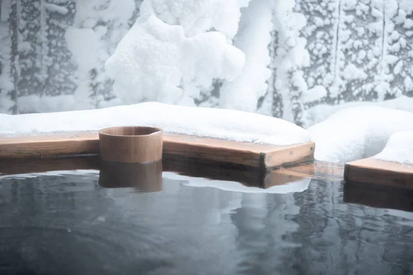 Japan natural mineral hot spring called onsen cover by snow in Japanese ryokan on the moutain okuhida takayama japan