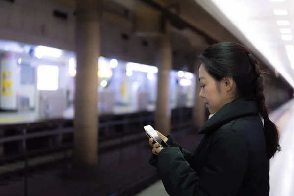 stock image Close up of happy asian woman waiting train go to work in railway station Tokyo Japan.