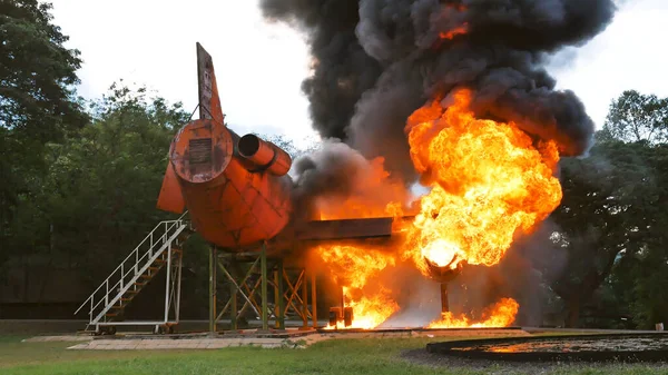 Firefighter fighting with flame using fire hose chemical water foam spray engine. Fireman wear hard hat, body safe suit uniform for protection. Rescue training in fire fighting extinguisher