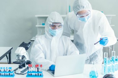 Bilim adamı covid-19 virüs kimya araştırması biyoteknoloji antikor örneği laboratuvarı virüse karşı aşı üretiyor. Bilim adamı mikroskoba bakıyor, bilim test tüpü kimya laboratuvarını analiz ediyor.