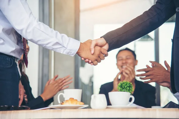 Team Business Partners shaking hands together to Greeting Start up small business in meeting room. Shakehand teamwork partners at modern office handshake together. Business mergers and acquisitions