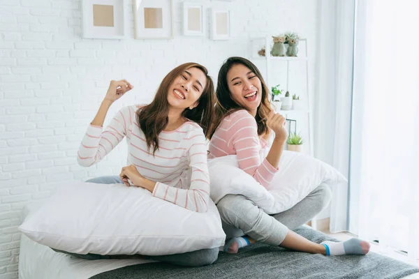Two pretty best friends forever girlfriend talk, hug and laugh together on bed at cozy home relation fall in love. Lesbian couple homosexual happy lifestyle on bed. LGBTQ relation lifestyle concept.