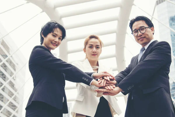 Teamwork Together Concept. Group of diversity people high five on air to greeting power of tag team. Multiethnic people group working togetherness. Volunteer collaboration in Business Team success