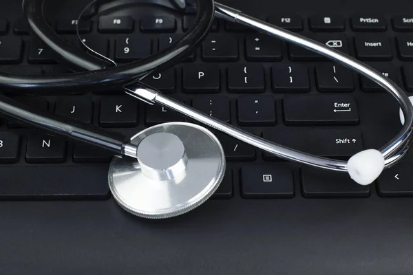 Stethoscope on the keyboard illustrating the medical industry / Medical information concept