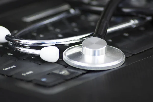 Stethoscope on the keyboard illustrating the medical industry / Medical information concept