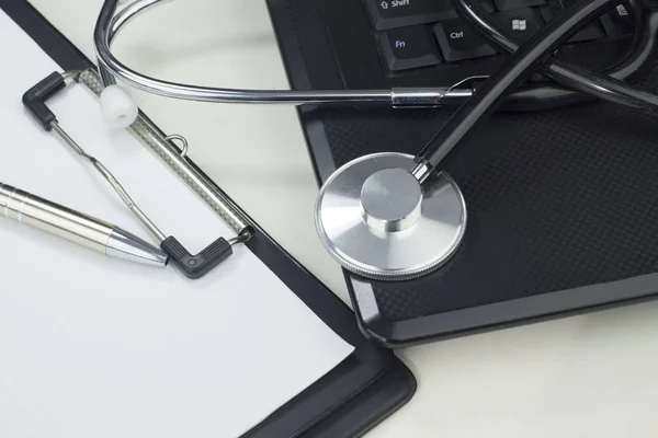 Stethoscope on the keyboard illustrating the medical industry / Medical information concept