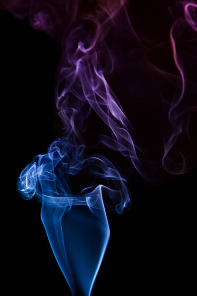 Movement of blue smoke on black background
