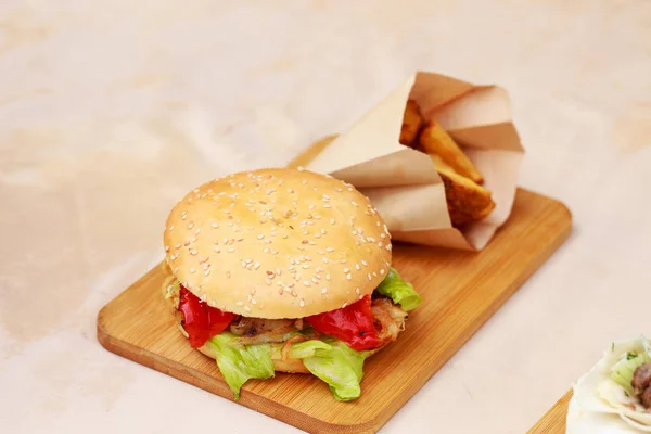 Burger on a wooden board — Stock Photo, Image