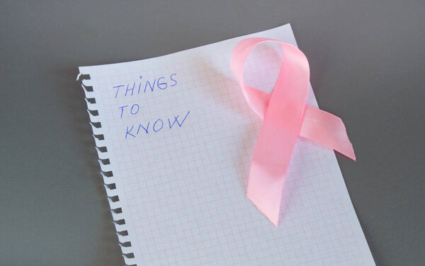Things to know is written in Notepad with pink ribbon awareness breast cancer