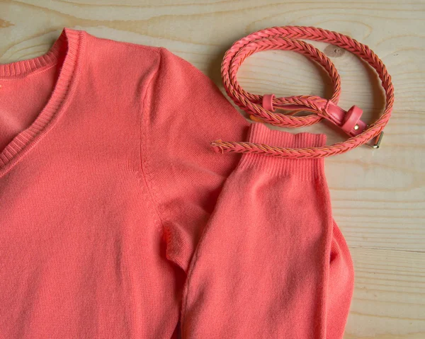 Jersey rosa de moda para mujer con cinturón sobre fondo de madera claro — Foto de Stock