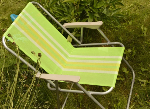 Camping chair is set in the garden on the grass — Stock Photo, Image