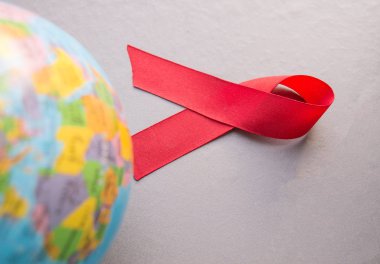 Dünya AIDS Günü 1 Aralık, dünya küre kırmızı kurdele ile yakın çekim