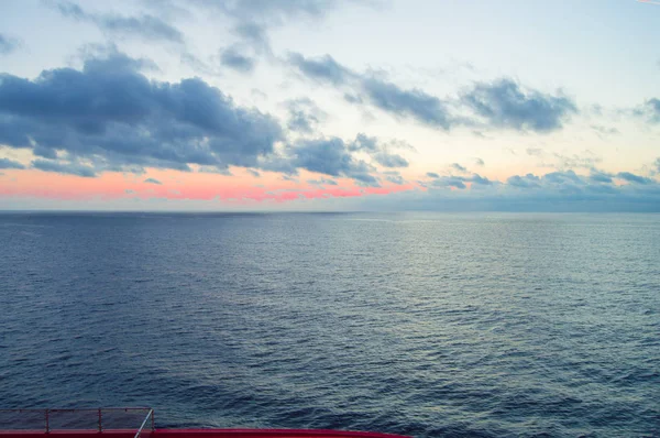 Beautiful sunset and silver path on the sea, blue clouds in the sky, background — Stock Photo, Image