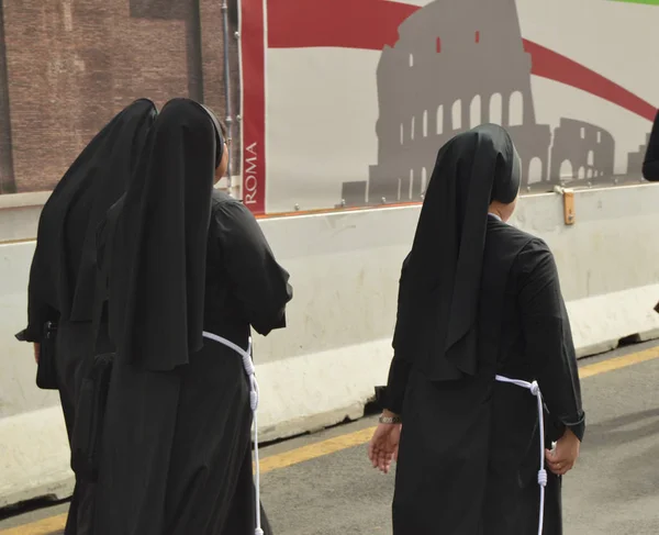 Roma, Italia-07 de octubre de 2018, tres monjas vestidas con túnicas negras caminando por las calles de Roma, la vista desde la parte posterior — Foto de Stock