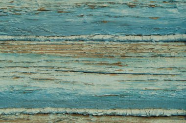 Eski kütüklerden duvarlar, makro. Arkaplan deseni mavi soyulmuş boya.