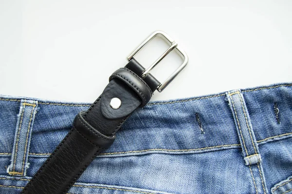 Blue jeans and black leather strap isolated on white background, mens casual clothing — Stock Photo, Image