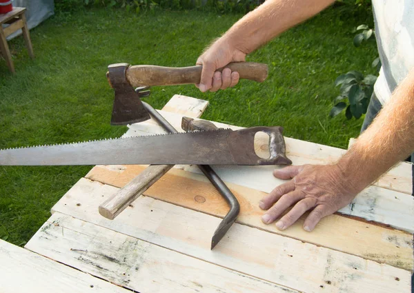 Homme tenant la hache, travaillant avec des outils de construction dans son jardin — Photo