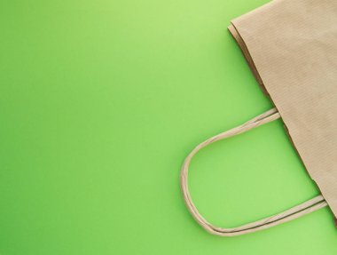 Sıfır atık kavramı, alışveriş için yeniden kullanılabilir kağıt torba, ücretsiz plastik, yeşil arkaplan, üst görünüm
