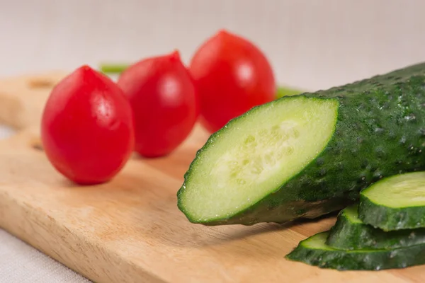 Pepino, tomates cereja no close-up Board. Foco seletivo — Fotografia de Stock