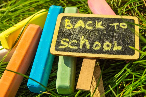 Ritorno a scuola, l'iscrizione sul mini-Board, la disposizione del Board e il gesso sull'erba verde, il concetto di preparazione per la scuola. Copia spazio — Foto Stock