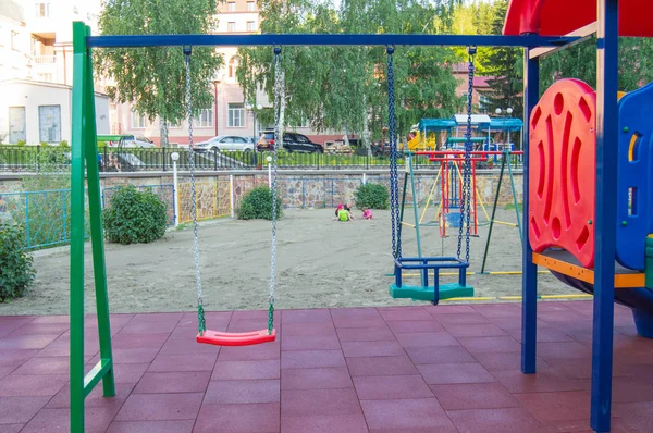 夏の日に公園の遊び場で空のカラフルなプラスチックの赤ちゃんのスイングのクローズアップ — ストック写真