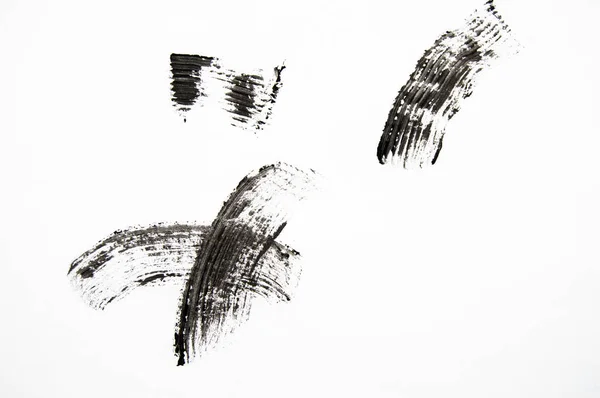 Esfregaço e textura de rímel preto isolado sobre fundo branco — Fotografia de Stock