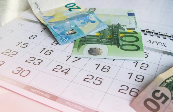 Euro ve takvimdeki dolar banknotları. Vergi raporu, kriz, finans, iş ve planlama.