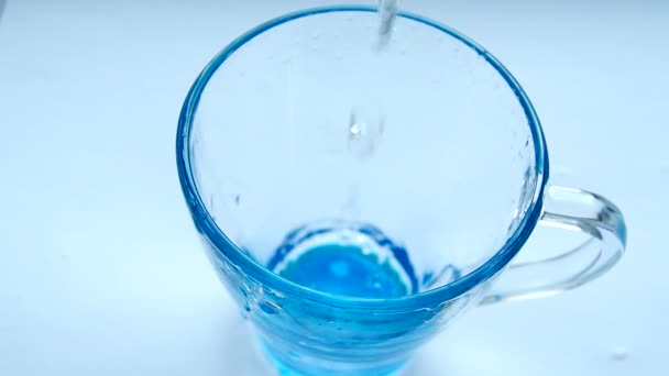 将清水倒入桌子上的蓝玻璃杯中 健康饮食理念 白色背景隔离 Hd视频 — 图库视频影像