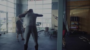 Spor salonunda çapraz fit antrenman yapan kişiler 