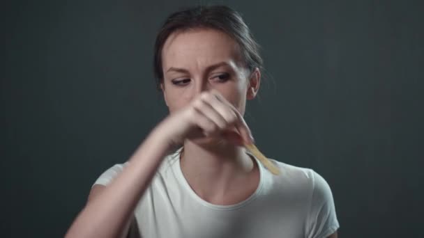 Young woman playing with food. Isolated black. Portrait. — Stock Video