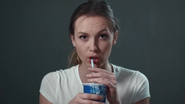 Young woman drinks soda. Isolated black. Portrait. — Stock Video