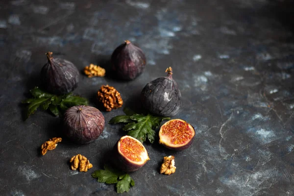 Ripe, beautiful, purple figs.  Sweet and juicy.  Mediterranean fruit is very healthy.  You can jerk and cook jam.  There is empty space on a dark copyspace background.  Food for vegetarians.