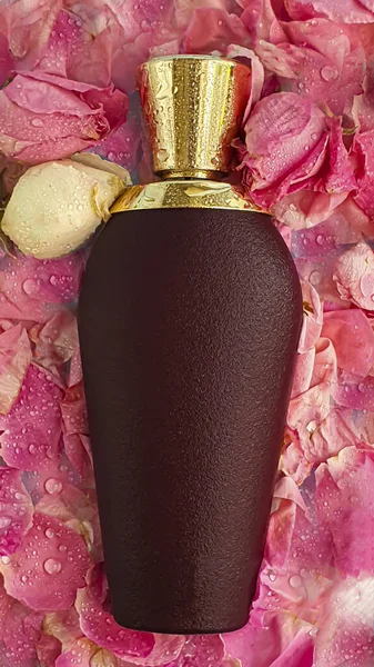Velvet bottle with women\'s perfume. Surrounded by rose petals on a light background. Copy space