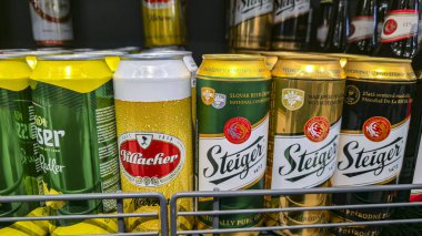 Alcoholic beverages displayed for sale on a store counter. Beer and champagne. Well-known brands.