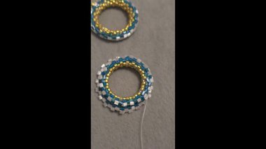 Handmade beaded and glass bead earrings on a light background. Copy space