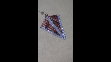 Handmade beaded and glass bead earrings on a light background. Copy space