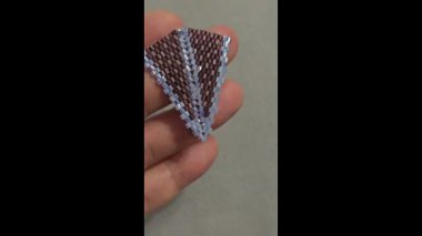 Handmade beaded and glass bead earrings on a light background. Copy space